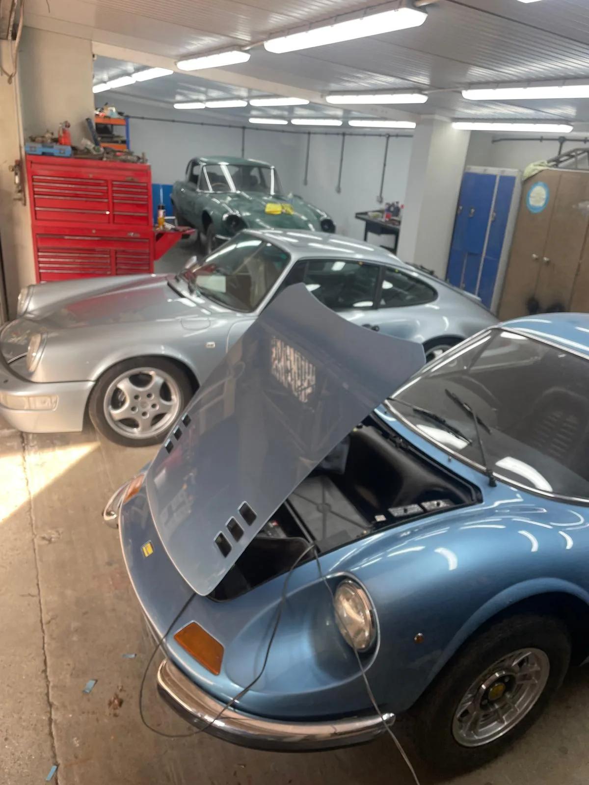 Classic coupe shell in bare metal and primer at Welch Automotive
