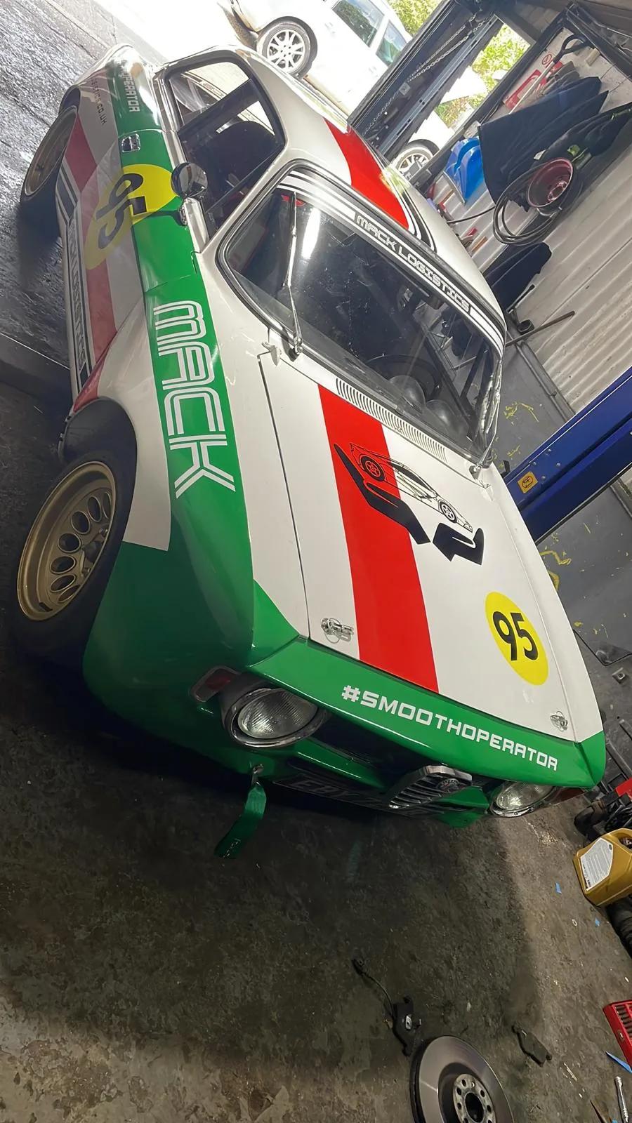 Classic race car rear three-quarter with Italian tricolour livery